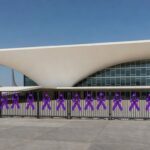 Edifício da CLDF em Brasília com laços roxos simbolizando falhas no combate à violência contra mulheres.