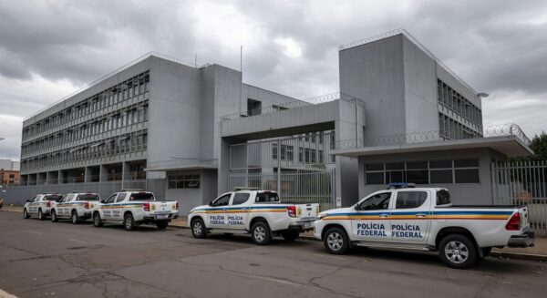 Exterior da prisão Papuda em Brasília com viaturas da Polícia Federal, representando a Operação Compliance Zero.